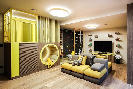 The multi-generational play and hobby room, with its refreshing colors and plays with geometry, is a favorite place for family gatherings